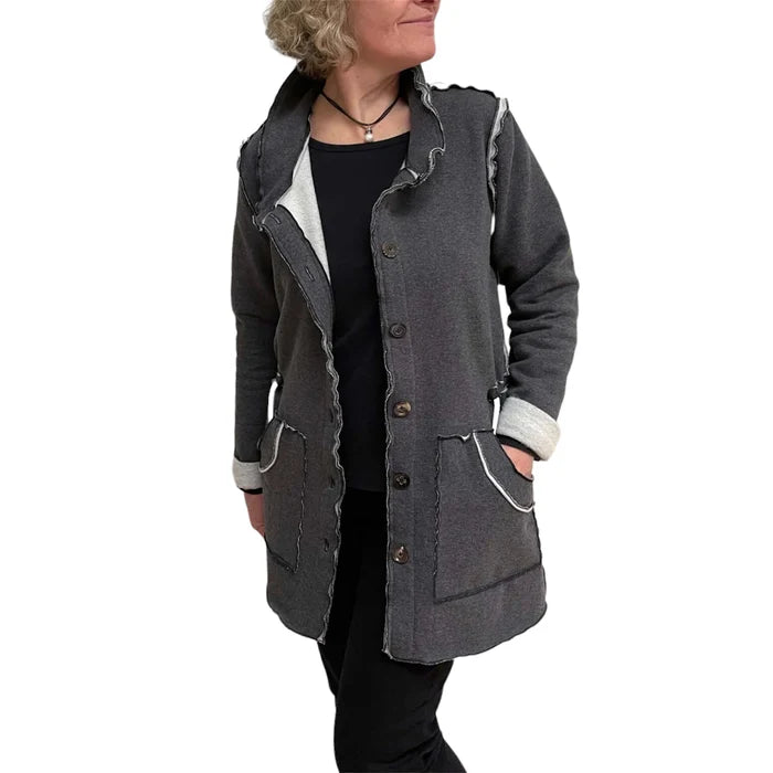 Person wearing a gray coat with white trim on a white background