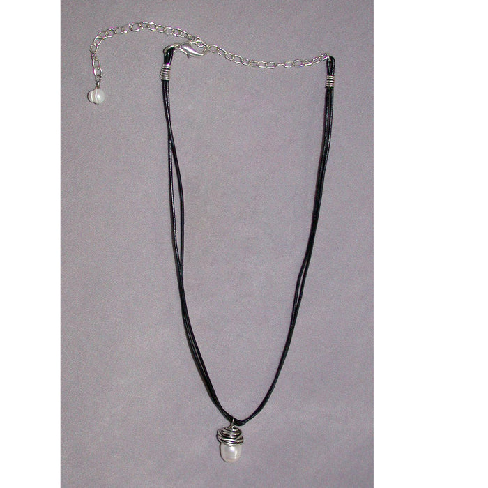 Necklace with black cord and silver pendant on a gray background