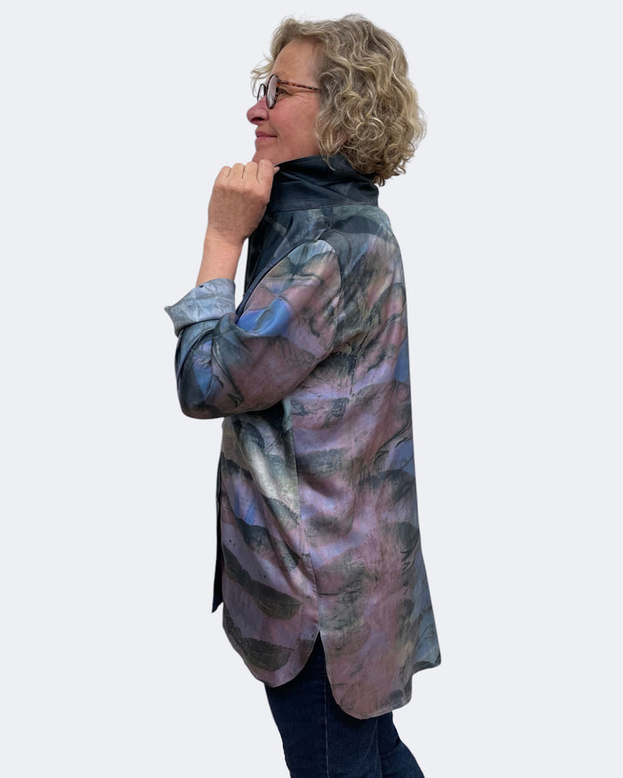 Woman wearing a patterned shirt against a white background