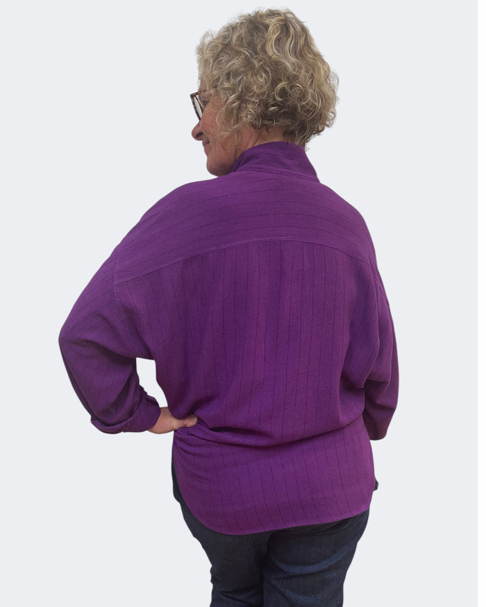 Person wearing a purple shirt on a white background