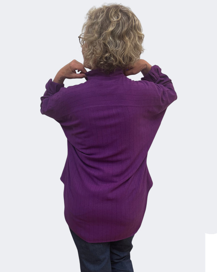 Person wearing a purple sweater on a white background