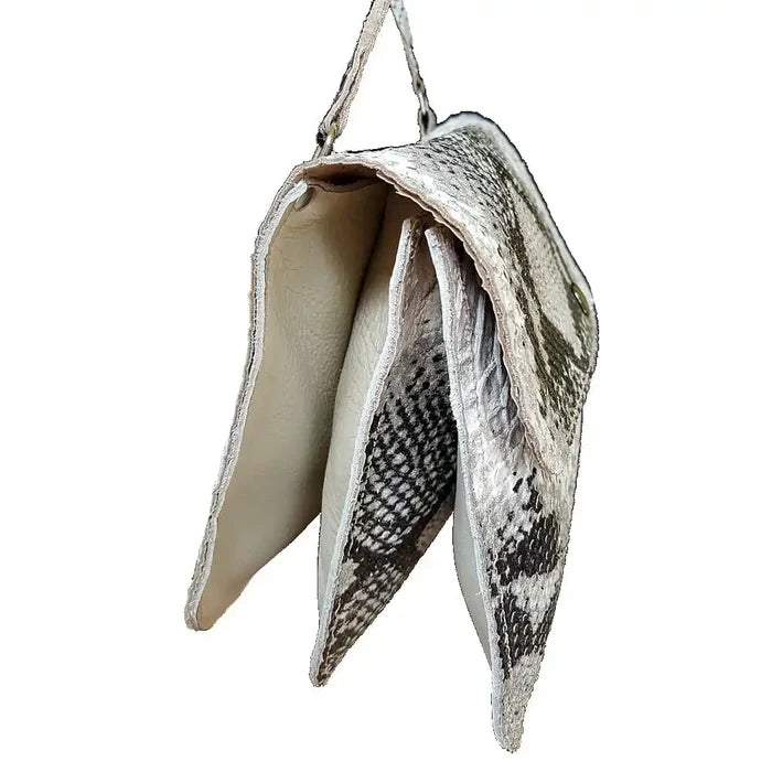 Snakeskin-patterned clutch bag on a white background