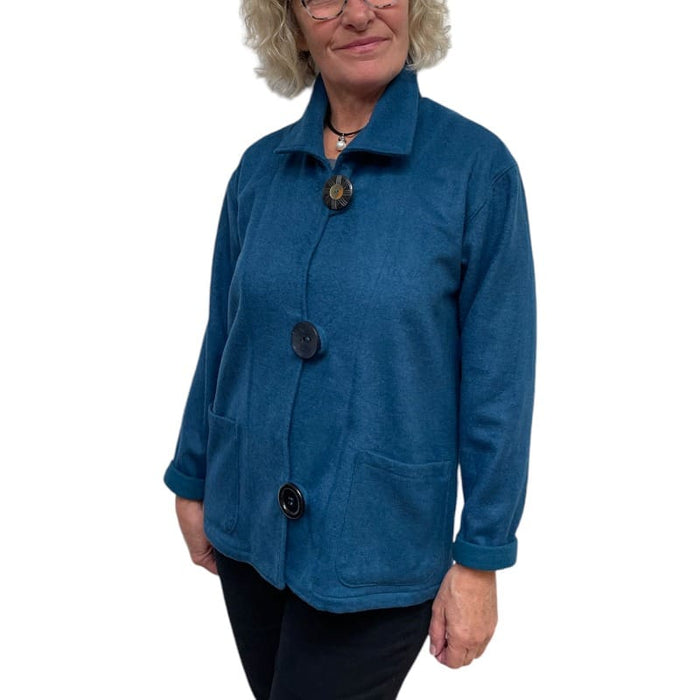Person wearing a blue jacket with buttons on a white background