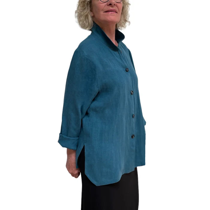 Person wearing a teal button-up shirt on a white background