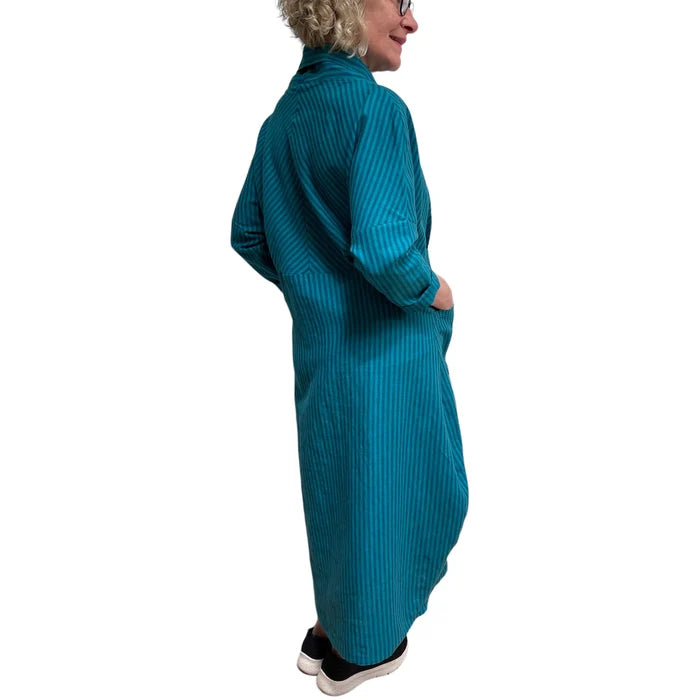 Person wearing a teal ribbed dress on a white background