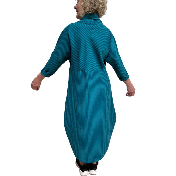 Person wearing a teal ribbed dress on a white background