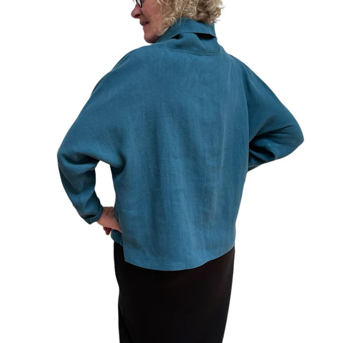 Person wearing a blue jacket on a white background