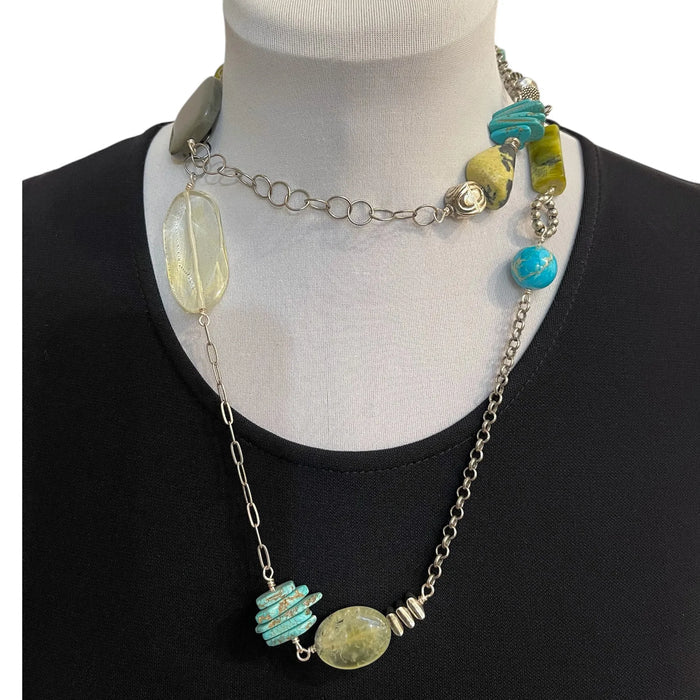 Necklace with colorful beads on a mannequin wearing a black top.