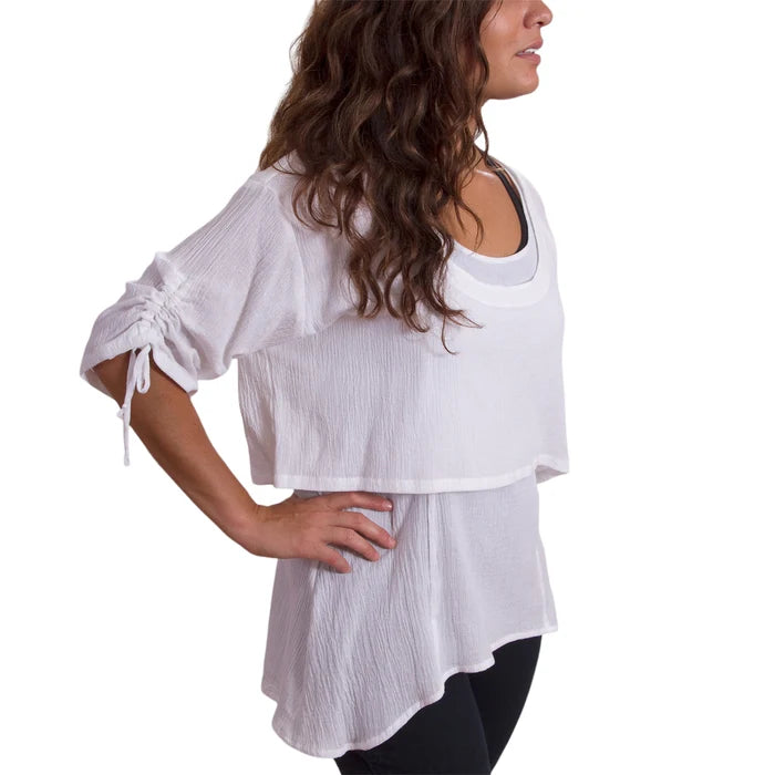Woman wearing a white blouse with a plain background