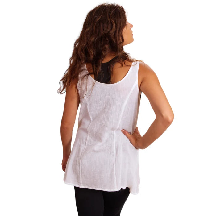 Woman wearing a white sleeveless top on a white background