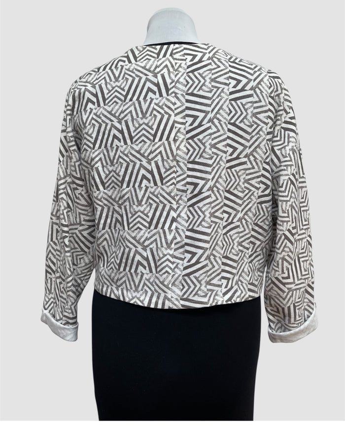 Black and white patterned blouse on a mannequin against a white background